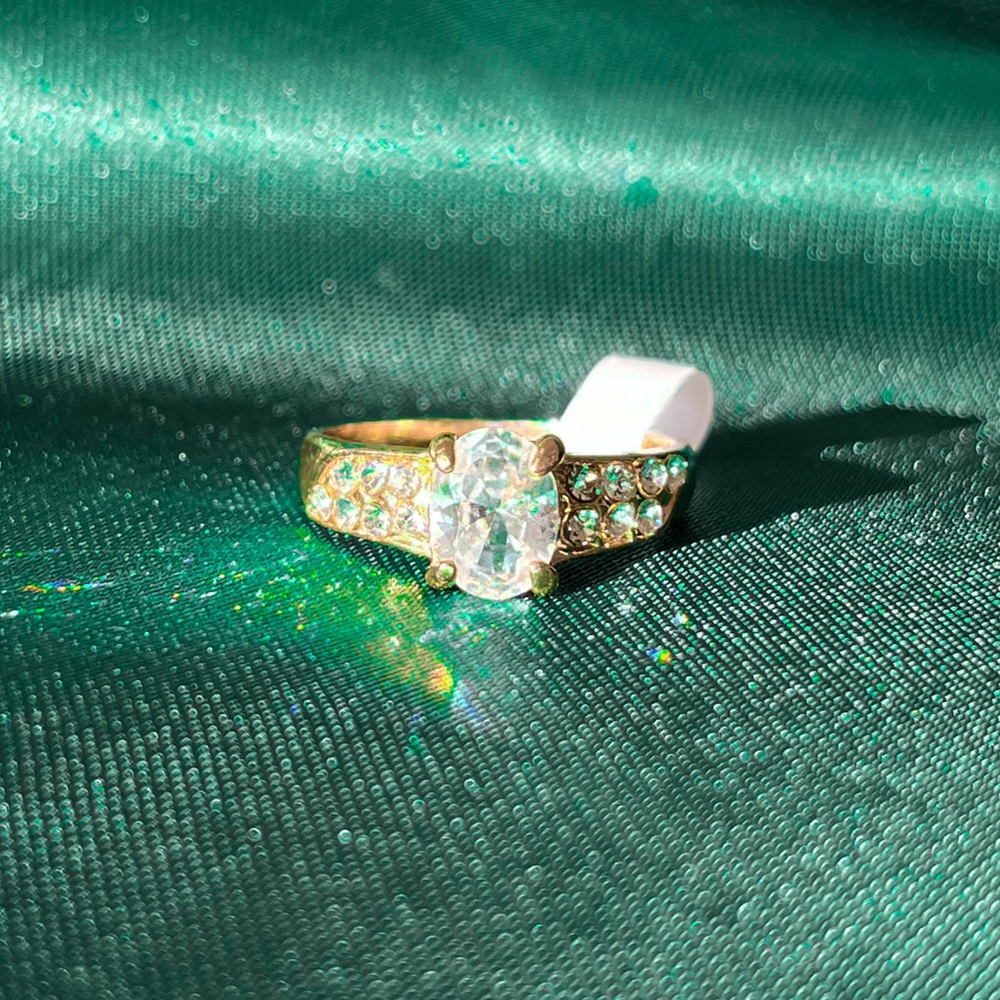 Gold Alloy Ring With An Oval Clear Gems